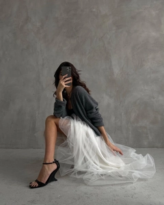 Elegant multi-layer white tulle skirt styled with grey cardigan and high heels