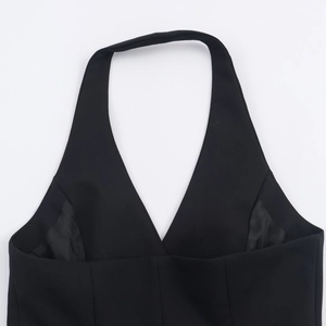 Detail view of the deep V-neckline and halter strap design on the black sleeveless vest