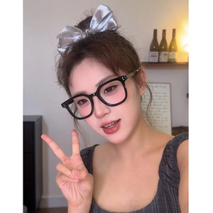 Chic black frame glasses with light pink lenses shown on a model in a lifestyle setting