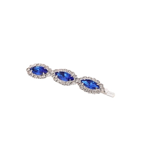 Macro shot of blue marquise gemstone hair clip with sparkling crystal rhinestone border