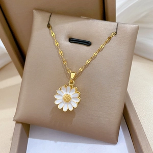 Detailed view of a spinning sunflower necklace with sparkling crystals in a jewelry box