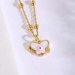 Gold-plated butterfly pendant necklace featuring a pink evil eye and beaded chain