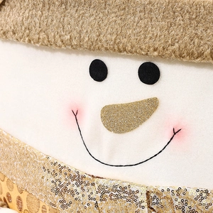 Detailed view of snowman chair cover with gold sequins and soft white faux fur texture