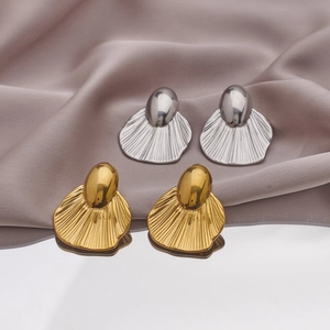 Minimalist gold and silver stainless steel bow fan earrings on silk background