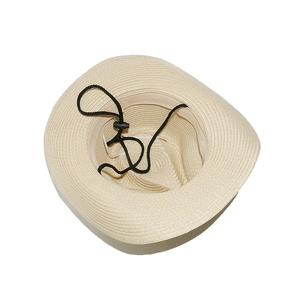 Detail view of beige woven straw hat interior with adjustable black windproof chin strap