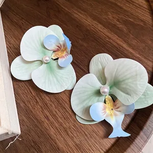 Chic orchid flower hair clips with pearl centers in gradient green and blue tones