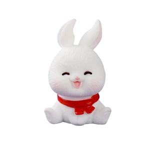 Cute white Christmas resin bunny figurine with red scarf on a clean white background