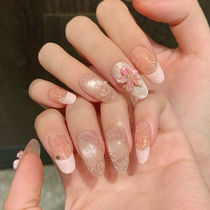 Pink French almond press-on nails with 3D handmade flowers and white lace patterns
