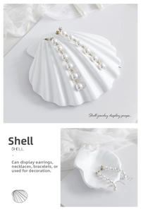 Detailed view of a white shell-shaped jewelry display stand with elegant radial texture