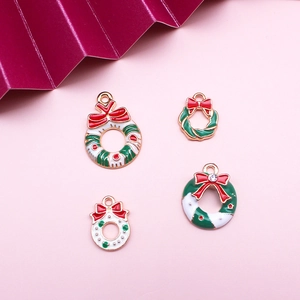 Detailed view of alloy enamel Christmas wreath charms with rhinestones on pink background