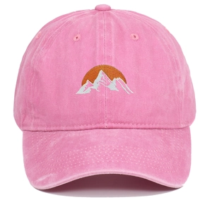 Close-up of pink washed cotton baseball cap featuring mountain sun embroidery detail