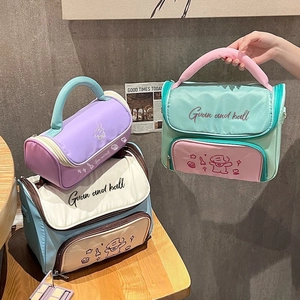 Close-up of macaron-colored cosmetic bags with cartoon prints and handle details