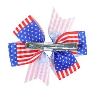 Handmade American flag bow hair clip with red, white, and blue ribbon for girls