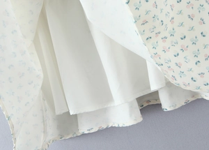 Détail du tissu à fleurs avec doublure blanche et texture élégante de l'ourlet en mousseline