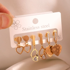 Three pairs of gold stainless steel heart earrings with zircon accents and drops