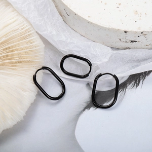 Minimalist black oval stainless steel hoop earrings shown from multiple angles