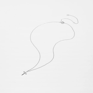 Macro shot of S925 sterling silver cross sword pendant and fine chain texture detail
