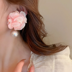 Pink fabric flower earrings with faux pearls on model for a sweet summer aesthetic