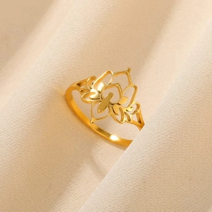 Detailed close-up of a hollow-out gold lotus flower ring with sparkling zircon stones