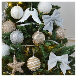 Detailed close-up of champagne glitter baubles and star ornaments on a Christmas tree branch