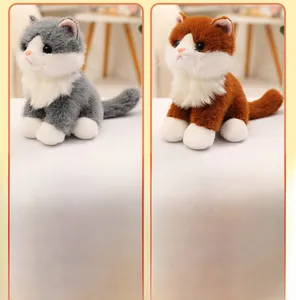 Close-up of plush grey and brown cats featuring soft faux fur and realistic facial details