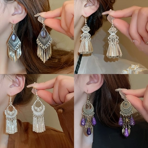 Bohemian retro tassel earrings set with silver metal filigree and purple bead accents