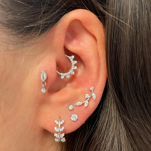 Detailed view of silver S925 earrings set with heart leaves and zircon stud on ear