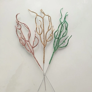 Close-up of sparkling pink gold and green glitter branches for festive Christmas decoration