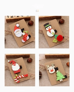 Detail showing four styles of Christmas hair clips including reindeer and snowmen designs