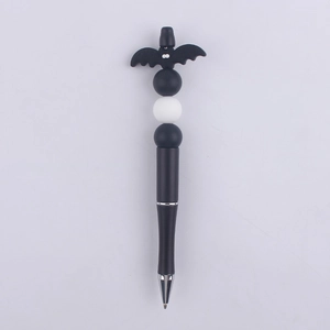 Detail of DIY beaded pen featuring a black cartoon bat topper and silicone beads