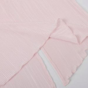 Detail of light pink plissé fabric with vertical pleats and lettuce edge stitching