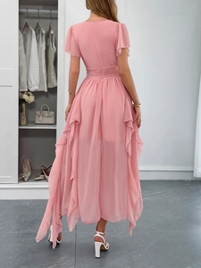 Rear view of pink chiffon maxi dress with ruffled layers and irregular flowing hem