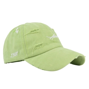 Detailed view of the distressed vintage baseball cap with white embroidery and ripped fabric