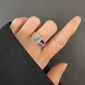 Close-up of a men's 925 sterling silver ring featuring a round cut diamond on the hand