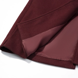 Detailed close-up of wine red wool coat hem featuring high-quality silky satin lining