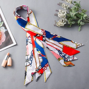 Elegant narrow silk scarf with blue and red chain patterns shown with floral decor