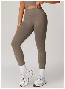 Detailed texture of seamless high-waist yoga leggings and matching sports bra in taupe