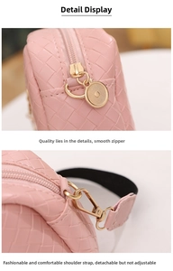 Detail of pink woven texture crossbody bag with detachable strap and golden zipper