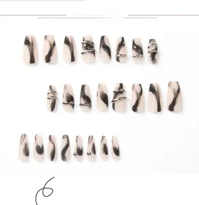 Detail of marble pattern press-on nails with silver rings and stud accents