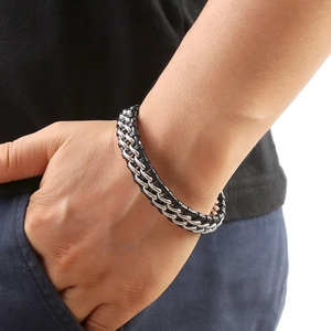 Men's double-layer braided black leather and silver metal chain link bracelet on wrist
