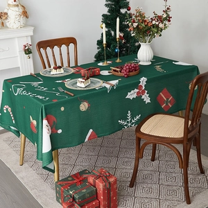 Deep green Christmas tablecloth with Santa and snowflakes for festive dining decor