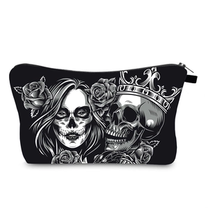 Detailed view of waterproof cosmetic bag with skull and rose motifs on black canvas