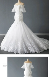Detail of off-shoulder wedding dress featuring lace embroidery and sparkling beadwork