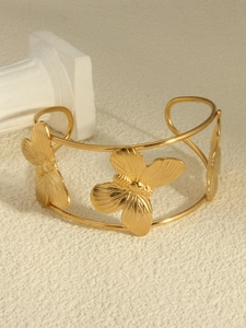 Detail showing elegant gold butterflies on 18k vacuum plated stainless steel cuff bracelet