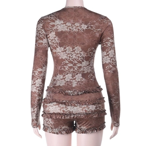 Detail of ruffled brown floral print romper back view on a mannequin display