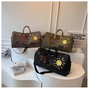Close-up of three stylish travel duffle bags with hand-drawn graffiti art on high-quality canvas