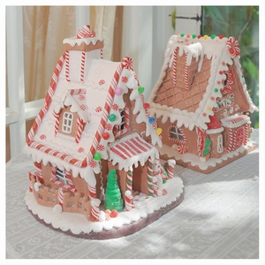 Detail of light-up clay gingerbread house with frosting texture and candy ornaments