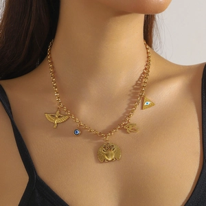 Gold stainless steel necklace featuring beetle, evil eye, and pyramid charms on a model