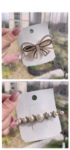 Detailed view of pearl bow hair clips with rhinestones and gold alloy finish