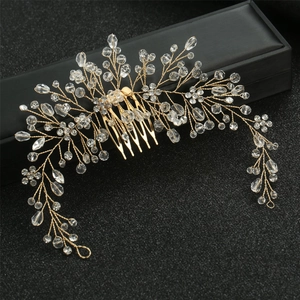Macro shot of gold bridal hair comb with crystals on a black jewelry box